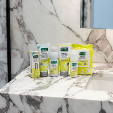 Set of cleaning products on a marble shelf with a marble wall background